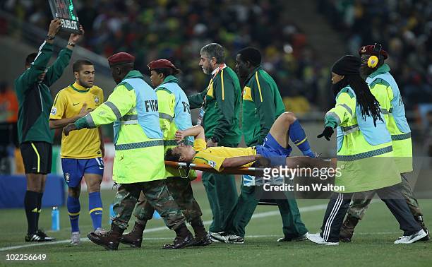 Elano of Brazil receives treatment and is stretchered off after a hard challenge during the 2010 FIFA World Cup South Africa Group G match between...