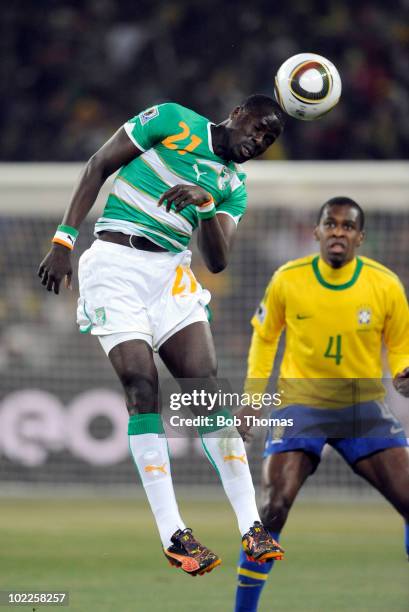 Emmanuel Eboue of the Ivory Coast heads away the ball during the 2010 FIFA World Cup South Africa Group G match between Brazil and Ivory Coast at...