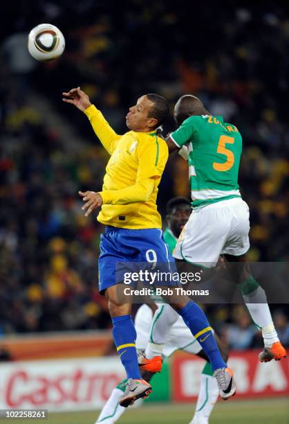 Luis Fabiano of Brazil heads the ball with Didier Zokora of the Ivory Coast during the 2010 FIFA World Cup South Africa Group G match between Brazil...