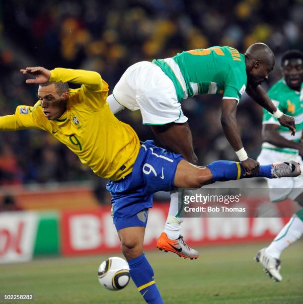 Luis Fabiano of Brazil clashes with Didier Zokora of the Ivory Coast during the 2010 FIFA World Cup South Africa Group G match between Brazil and...