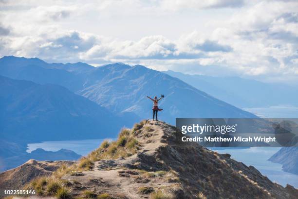 the strenuous yet highly rewarding hike to roy's peak in wanaka. the hike is difficult but the views are spectacular. it is common for people to take off their clothes to pose for photographs at this location. - sports top view ストックフォトと画像
