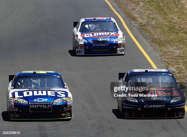Jimmie Johnson, driver of the Lowe's Chevrolet, Mattias Ekstrom, driver of the Red Bull Toyota, and Marcos Ambrose, driver of the Clorox Toyota,...