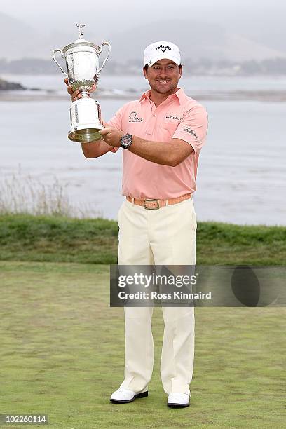 Graeme McDowell of Northern Ireland celebrates with the trophy on the 18th green after winning the 110th U.S. Open at Pebble Beach Golf Links on June...