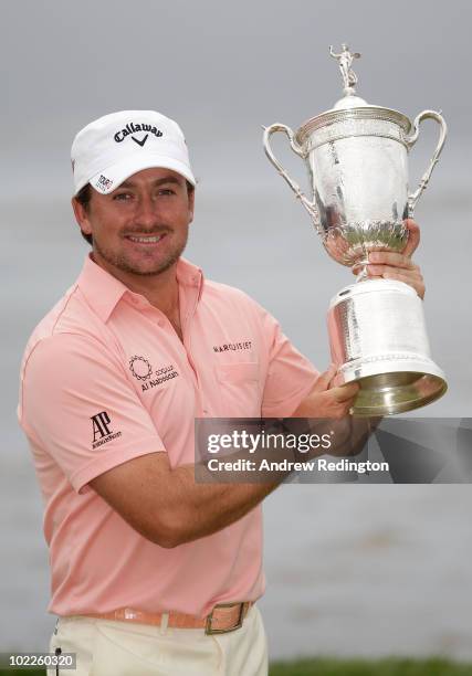 Graeme McDowell of Northern Ireland celebrates with the trophy on the 18th green after winning the 110th U.S. Open at Pebble Beach Golf Links on June...