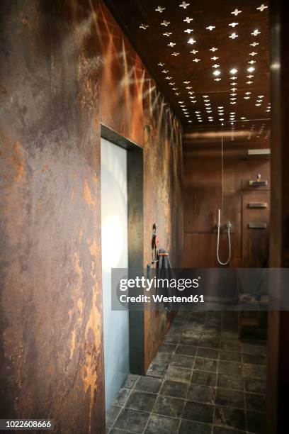 modern bathroom with corten steel wall cladding and ceiling light effects - patina stock pictures, royalty-free photos & images