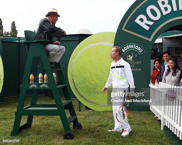 John McEnroe Tennis legend poses for photos to celebrate Robinson's 75th anniversary of their partnership with the Wimbledon Championships on June...