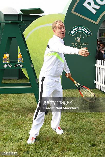 John McEnroe Tennis legend poses for photos to celebrate Robinson's 75th anniversary of their partnership with the Wimbledon Championships on June...