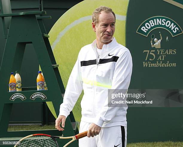 John McEnroe Tennis legend poses for photos to celebrate Robinson's 75th anniversary of their partnership with the Wimbledon Championships on June...