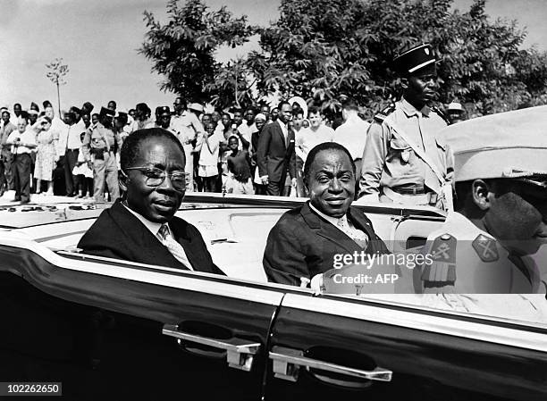 Ivory president Felix Houphouet Boigny and Senegalese President Leopold Sedar Senghor parade in the official car, on August 10, 1961 in Abidjan,...