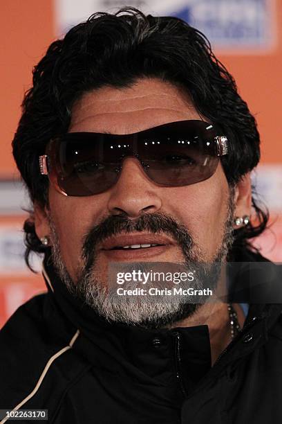Argentina's head coach Diego Maradona shows off a new pair of sunglasses given to him by his daughter as a fathers day gift during a press conference...