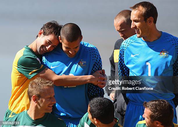Carl Valeri of Australia hugs goalkeeper Adam Federici while Mark Schwarzer looks on as the Australia Socceroos pose for an official 2010 FIFA World...