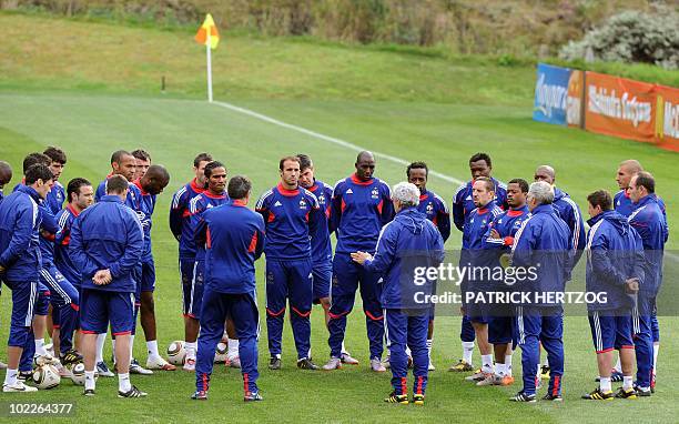 France's players listen to coach Raymond Domenech during a training session at the Field of Dreams in Knysna on June 21, 2010 during the 2010 World...