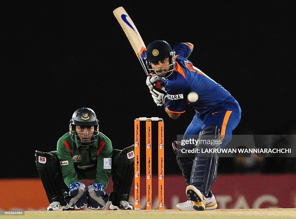 Indian cricketer Virat Kohli (R) is watc