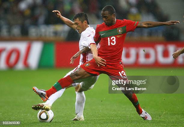 Miguel of Portugal tackles Pak Nam-Chol of North Korea during the 2010 FIFA World Cup South Africa Group G match between Portugal and North Korea at...