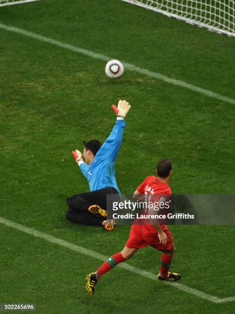 Simao of Portugal scores his side's second goal past Ri Myong-Guk of North Korea during the 2010 FIFA World Cup South Africa Group G match between...