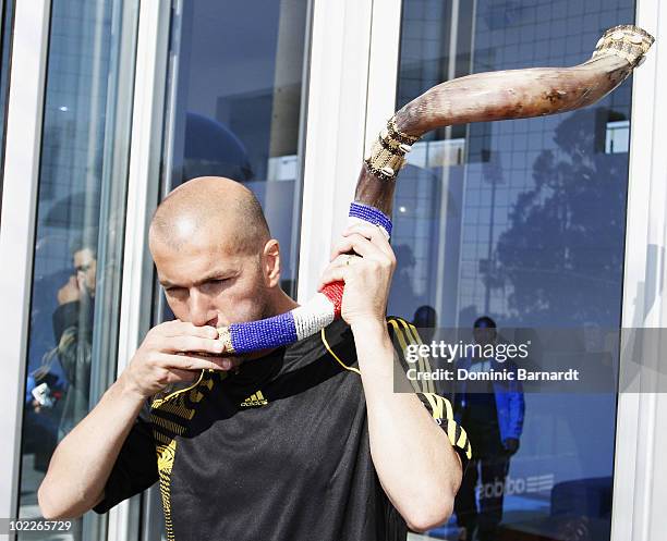 Zinedine Zidane blows a kudu horn during an adidas football masterskills training session with Lucas Radebe and Zinedine Zidane at Discovery Soccer...