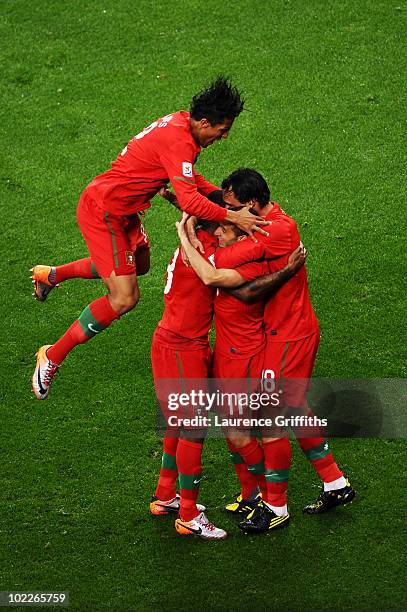 Simao of Portugal celebrates scoring his side's second goal past with team mates during the 2010 FIFA World Cup South Africa Group G match between...