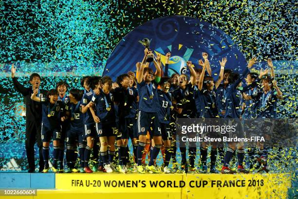 Moeka Minami of Japan lifts the trophy as Japan celebrate victory following the FIFA U-20 Women's World Cup France 2018 Final match between Spain and...