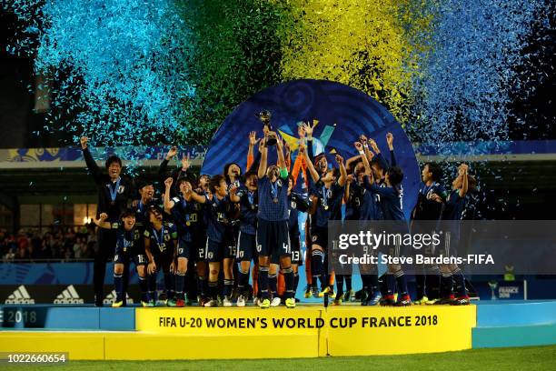 Moeka Minami of Japan lifts the trophy as Japan celebrate victory following the FIFA U-20 Women's World Cup France 2018 Final match between Spain and...