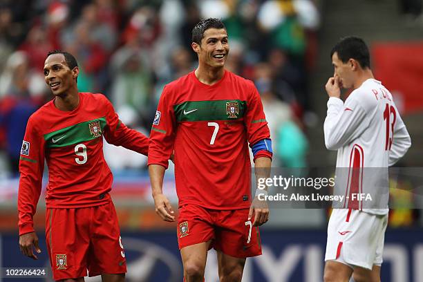 Cristiano Ronaldo of Portugal celebrates with team mate Liedson after scoring the seventh goal while Pak Chol-Jin of North Korea looks dejected...