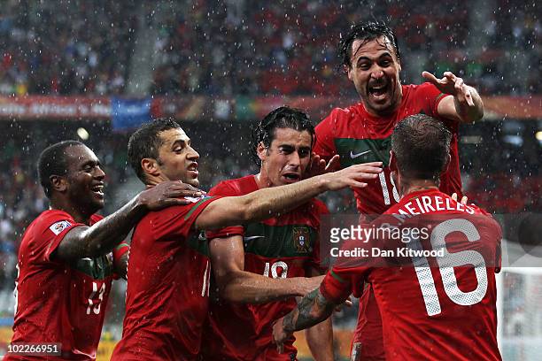 Raul Meireles of Portugal celebrates scoring the opening goal with team mates during the 2010 FIFA World Cup South Africa Group G match between...