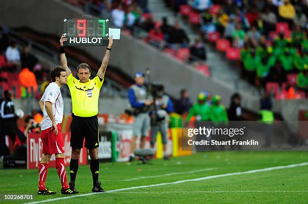 Substitute Tranquillo Barnetta of Switzerland waits by the touchline as the fourth official Martin Vazquez holds up the electronic board during the...