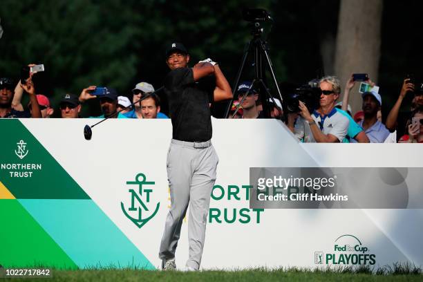Tiger Woods of the United States plays his shot from the 16th tee during the second round of The Northern Trust on August 24, 2018 at the Ridgewood...
