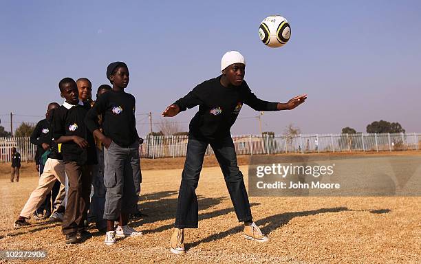 Disadvantaged youth practice headers while at a camp run by the South African Business Coalition on HIV/AIDS on June 21, 2010 in Soweto, South...