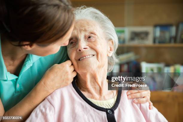 senior woman with home caregiver - nursing assistant stock pictures, royalty-free photos & images