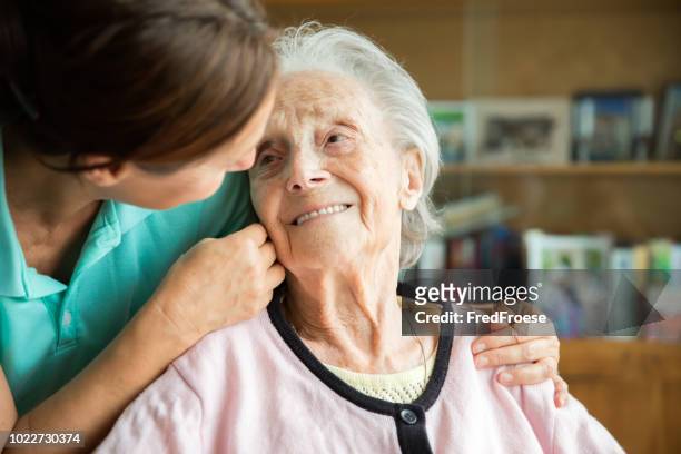senior woman with home caregiver - nursing assistant imagens e fotografias de stock