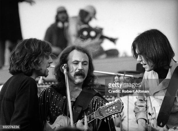 Graham Nash, David Crosby and Neil Young of Cosby Stills Nash and Young perform onstage at The Altamont Speedway on December 6, 1969 in Livermore,...