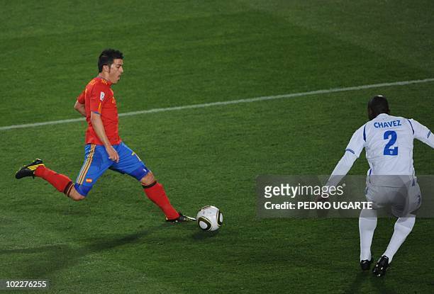 Honduras' defender Osman Chavez challenges Spain's striker David Villa as he advances with the ball before scoring against Honduras during the 2010...