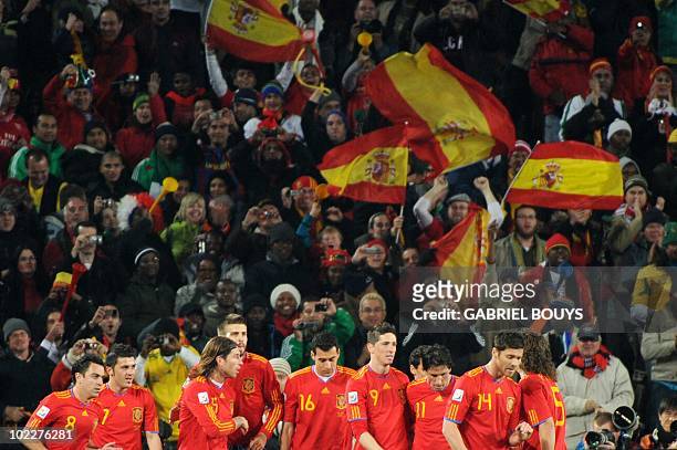 Spain's striker David Villa celebrates with teammates after scoring the opening goal during the Group H first round 2010 World Cup football match...