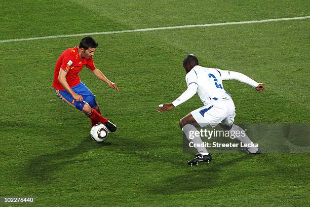 David Villa of Spain evades the challenge of Osman Chavez of Honduras to score the opening goal during the 2010 FIFA World Cup South Africa Group H...