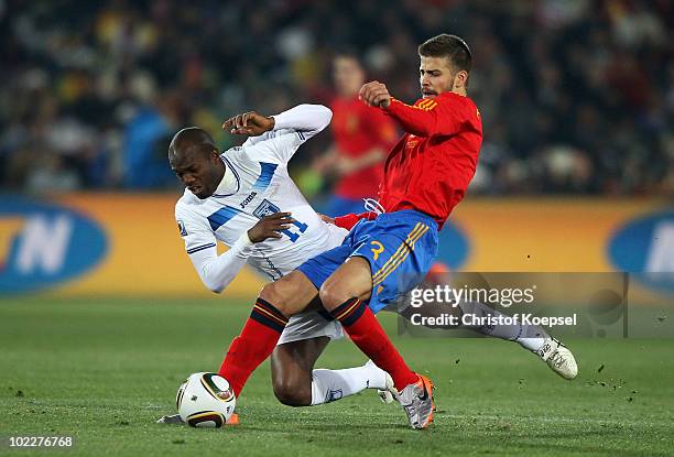 Gerard Pique of Spain tackles David Suazo of Honduras during the 2010 FIFA World Cup South Africa Group H match between Spain and Honduras at Ellis...