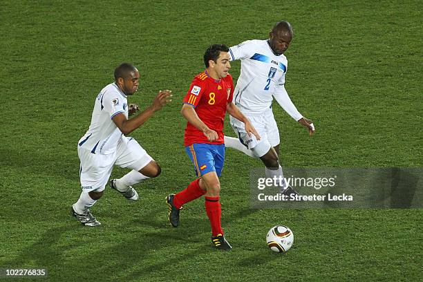 Wilson Palacios and Osman Chavez of Honduras challenge Xavi Hernandez of Spain during the 2010 FIFA World Cup South Africa Group H match between...