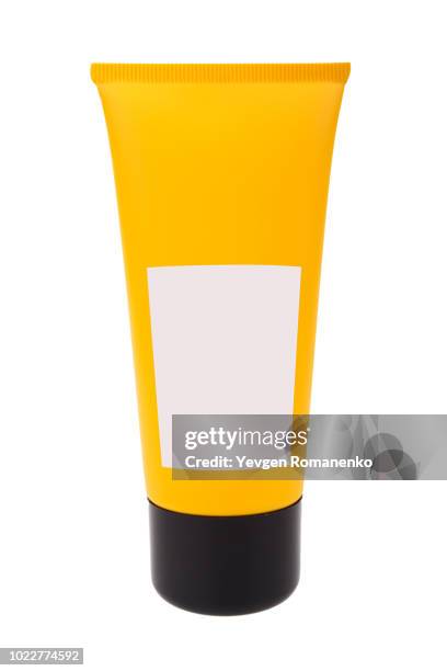 blank yellow cream tube on white background - creme tube ストックフォトと画像