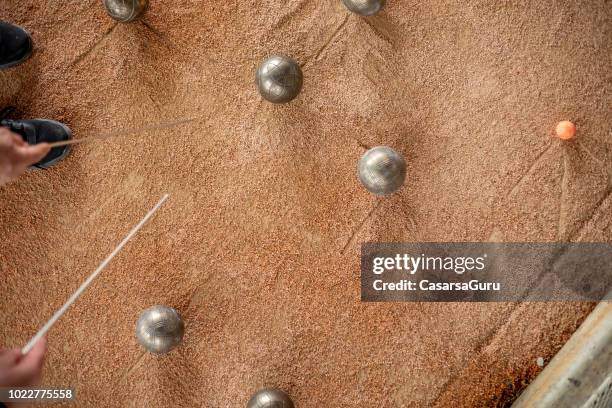 senior woman marking where bocce ball has stopped - petanque stock pictures, royalty-free photos & images