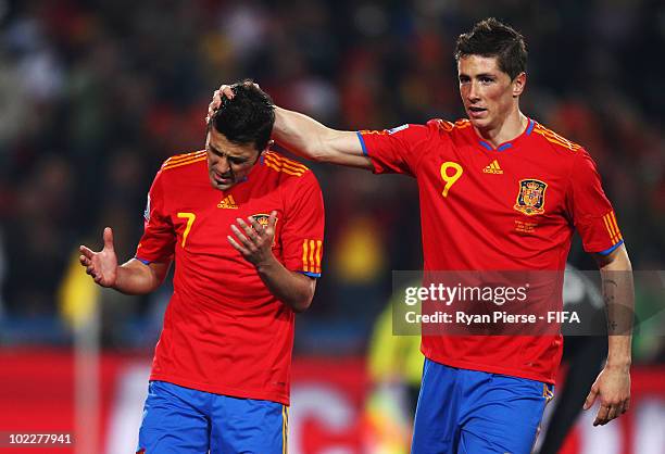 David Villa of Spain is comforted by his team mate Fernando Fabregas after missing to score a penalty during the 2010 FIFA World Cup South Africa...