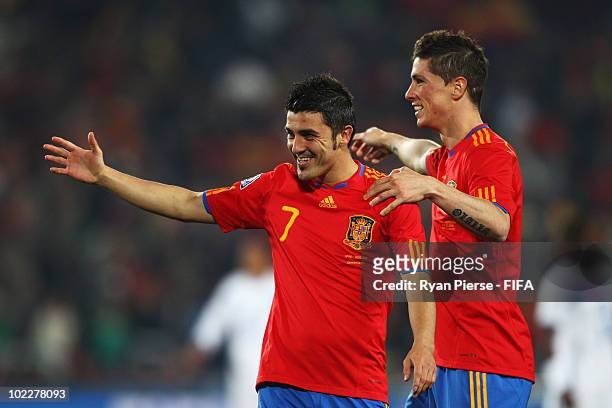 David Villa of Spain celebrates with team mate Fernando Torres after scoring the second goal during the 2010 FIFA World Cup South Africa Group H...