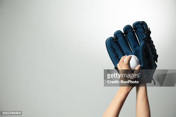 hand holding  baseball glove and ball - baseball glove isolated stock pictures, royalty-free photos & images