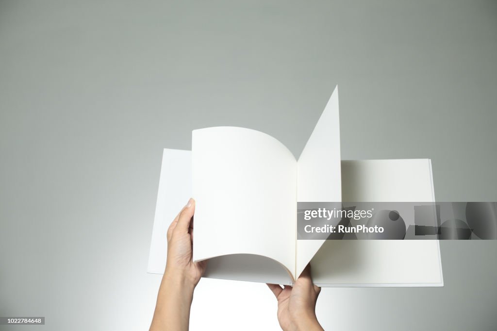 Hands holding blank book