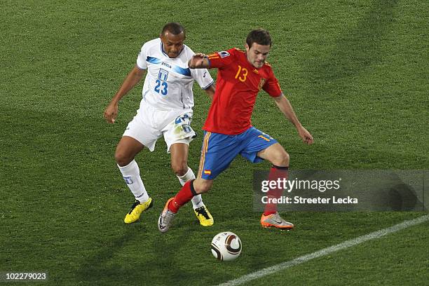 Sergio Mendoza of Honduras and Juan Manuel Mata of Spain battle for the ball during the 2010 FIFA World Cup South Africa Group H match between Spain...