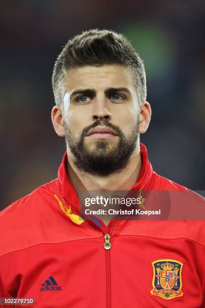 Gerard Pique of Spain lines up for the national anthems prior to the 2010 FIFA World Cup South Africa Group H match between Spain and Honduras at...
