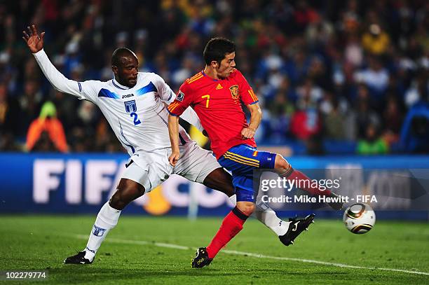 David Villa of Spain is challenged by Osman Chavez of Honduras during the 2010 FIFA World Cup South Africa Group H match between Spain and Honduras...