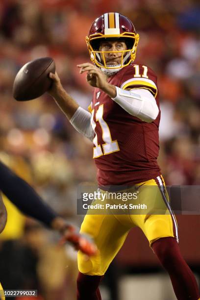 Quarterback Alex Smith of the Washington Redskins looks to pass against the Denver Broncos in the first half during a preseason game at FedExField on...