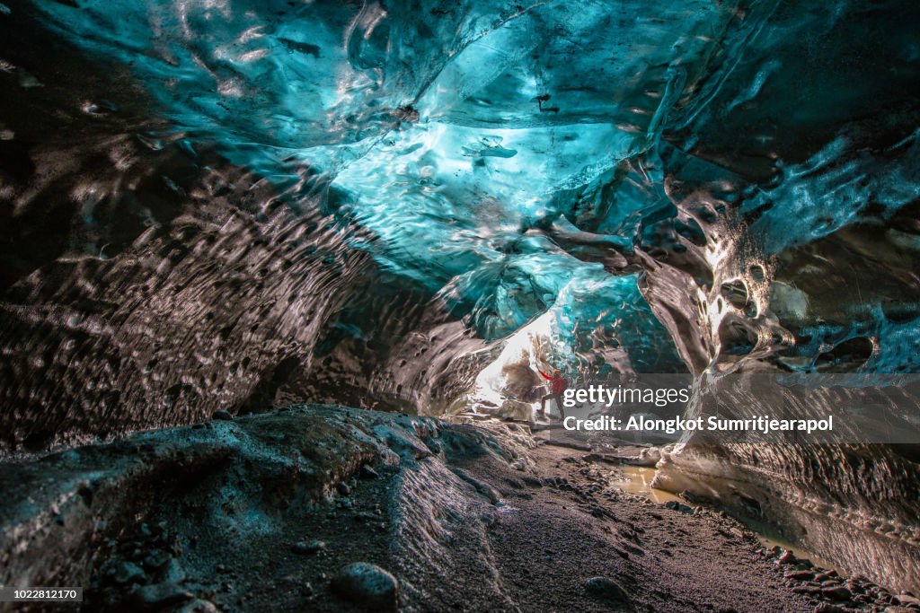 Entrance of an ice cave with an Explorer inside Vatnajokull glacier in southern Iceland.