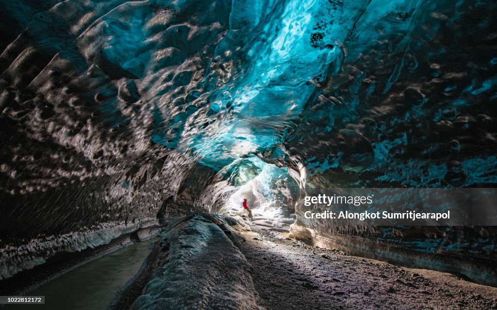 Entrance of an ice cave with an Explorer inside Vatnajokull glacier in southern Iceland.