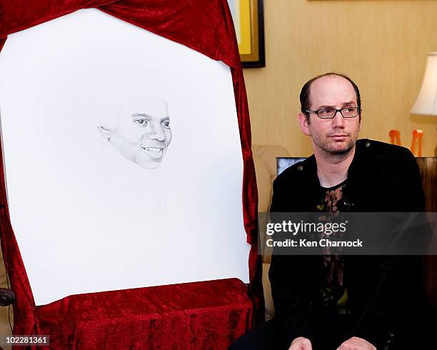 Artist, David Ilan, shows the placement of the dot he added for Dr. Maya Angelou in support of The Michael Jackson Tribute Portrait at the home of...