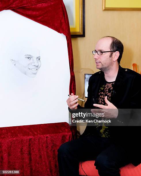 Artist, David Ilan, shows the placement of the dot he added for Dr. Maya Angelou in support of The Michael Jackson Tribute Portrait at the home of...